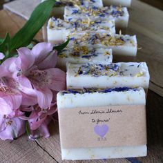 soap bars with lavender and chamomile on them next to some pink flowers