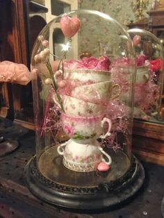 a glass clochet with pink roses in it