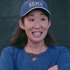 a woman in a baseball uniform is smiling