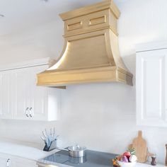 a stove top oven sitting inside of a kitchen next to white cabinets and counter tops