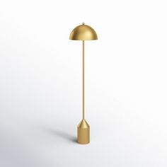 a gold floor lamp on a white background with the light turned on and one arm extended