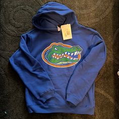 Florida Gators Sweatshirt, Blue Fleece Fan Merchandise Sweatshirt, Blue Cotton Hoodie For Fan Merchandise, Blue Hooded Hoodie For School, Winter School Blue Hoodie, Blue Fleece Fan Apparel Hoodie, Blue Fleece Hoodie Fan Apparel, Blue Fan Apparel Hoodie, Blue Winter Hoodie For Fans