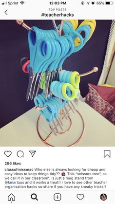 a bunch of scissors that are sitting on a stand in the middle of a table