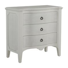 a white dresser with three drawers on it