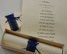 an open gift box with blue ribbon and poem in it, next to a card