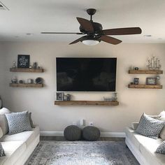 a living room filled with furniture and a flat screen tv mounted to the side of a wall