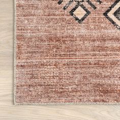 a brown and black rug on top of a wooden floor