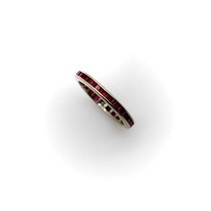 a white gold ring with pink and red stones