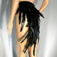 a mannequin with black feathers on it's back