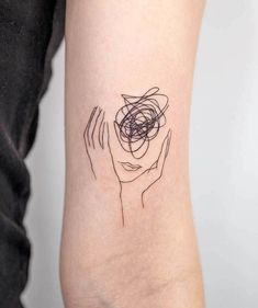 a woman's arm with an abstract tattoo design on the left side of her arm