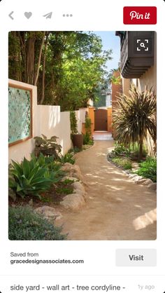 an outdoor walkway with plants and trees on either side