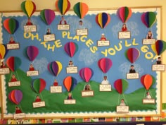 a bulletin board with many hot air balloons and people on the place you'll go