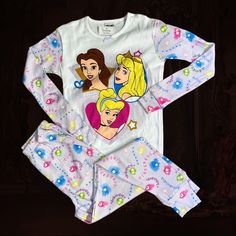 Disney Princess Longe Sleeve Pj Set Belle, Aurora, Cinderella On Shirt Front. Child 12 Lavender Sleeves And Pants With Princessess' Names. Disne Catalog Cute White Character Print Sleepwear, Cute White Sleepwear With Character Print, White Character Print Sleepover Sets, White Character Print Bedtime Sets, White Character Print Sets For Bedtime, White Bedtime Sets With Character Print, Long Sleeve Disney Sleepwear For Bedtime, White Character Print Bedtime Tops, Disney Long Sleeve Sets With Character Print