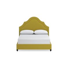 a bed with white pillows and yellow headboard