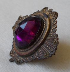 For your consideration we have a lovely Victorian era lapel pin/brooch in faux amethyst and set against ornate brass setting. Measuring approximately 1.5" long and 1.5" wide, this are a great accessory for any dapper gent or well turned out woman.Shipping policies:If you choose to pay via Paypal, you must either be a verified buyer, or provide a confirmed shipping address. If neither, we will contact you for confirmation or the sale will be canceled. We do accept payment via credit card over the Vintage Victorian, Lapel Pin, Victorian Era, Pin Brooch, Lapel Pins, Brooch Pin, Brooches, You Must, Cuff Bracelets