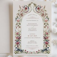 an ornate wedding card with flowers on it