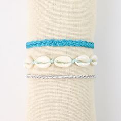 CORON BEACH BRACELET SET  Embrace the beauty of the ocean with our Coron Beach Bracelet Set. Crafted with ocean tones, this set will bring a touch of the sea to your everyday look. Perfect for any beach lover! - Made with natural cowrie shells, a dainty silver chain, soft nylon cord and our durable wax polyester cord. - All bracelets measure approx. 17cm with a 7cm sliding knot extension - Handmade in Bali. - Biodegradable or recycled packaging. OTHER INFORMATION   All items are nicely packaged and ready to gift in biodegradable packaging. You can also upgrade your order at checkout to include a gift box and a handwritten note, all made from recycled materials.   TURN AROUND TIME   This design is ready to ship in 1 business day.   MORE FROM US   https://www.etsy.com/shop/pineappleislanduk Cheap Ocean-inspired Vacation Bracelets, Surf Bracelets, Adjustable Shell-shaped Beachy Bracelets, Adjustable Ocean-colored Bracelets For The Beach, Beachy Adjustable Shell-shaped Bracelets, Ocean-inspired Shell-shaped Bracelets For The Beach, Cowrie Shell Bracelet, Bracelets Summer, Beachy Bracelets