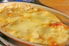 a casserole dish with cheese and meat in it