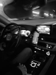 the interior of a car is shown in black and white, with dash lights on