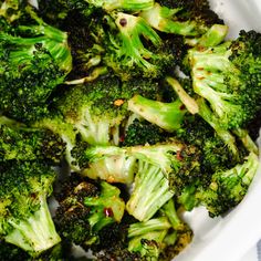 broccoli florets are in a white bowl