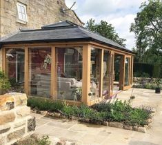 a garden room with an enclosed patio and seating area