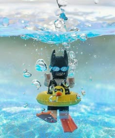 a lego batman character floating in the water