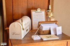 a mailbox sitting on top of a wooden table next to a couple of cards