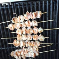 several skewers of food sitting on top of each other in front of a grill