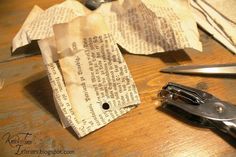 a pair of scissors sitting on top of a wooden table next to some pieces of paper