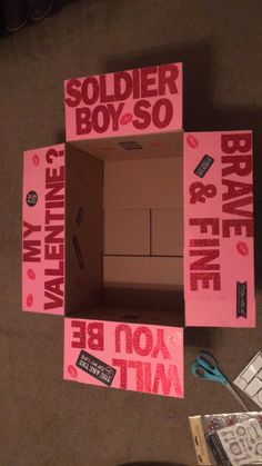 some pink boxes that are sitting on the floor and one is missing it's lid