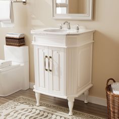 a white bathroom sink sitting next to a toilet in a room with beige walls and wooden floors