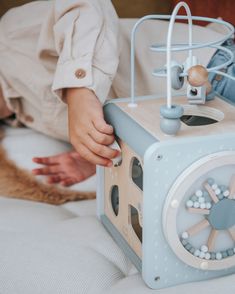 a child is playing with a toy on the bed