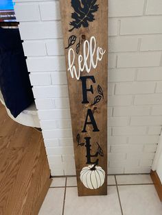 a wooden sign that says hello fah with pumpkins and leaves painted on it