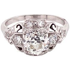 Vintage 1950s White Gold European Cut Diamond Filigree Ring - The center Old European Cut diamond weighs 1.20ct and is an I color and SI1 clarity. The diamond is set prominently in square fishtail prongs with 8 full cut diamonds accented on the ring. The hand carved filigree design makes a simple and elegant statement. The ring is a size US 5.5 and can be sized. The ring is stamped 14k. Filigree Design, European Cut Diamonds, Filigree Ring, Cocktail Rings, Vintage 1950s, Diamond Cuts, Hand Carved, Jewelry Rings, Silver Rings