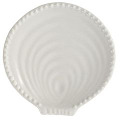 a white ceramic dish with wavy lines on it