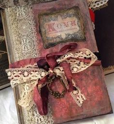 an old book with lace and ribbon tied around it