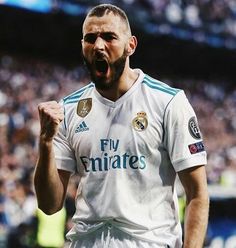 a soccer player with his mouth wide open in front of an audience at a game