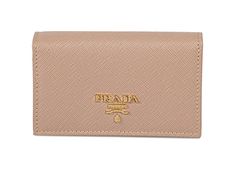 This Prada saffiano beige card holder wallet is the perfect size for your personal necessities. The gold Prada Milano logo looks amazing with the beige saffiano leather. Includes authenticity cards and Prada box.     Model: 1MC122  Cammeo beige saffiano leather   Gold-tone hardware  Gold Prada Milano logo   Snap closure  Three card slots  Measurements: 4.5" x 1" x 2.5"  (LWH)  Includes authenticity cards and Prada box   Made in Italy Luxury Gold Wallets With Logo Plaque, Elegant Gold Wallet With Rfid Blocking, Classic Gold Wallet With Logo Plaque, Luxury Gold Wallet With Rfid Blocking, Designer Gold Wallet With Card Slots, Designer Gold Wallets With Card Slots, Elegant Gold Card Holder For Travel, Elegant Gold Travel Card Holder, Luxury Gold Card Holder With Rfid Blocking