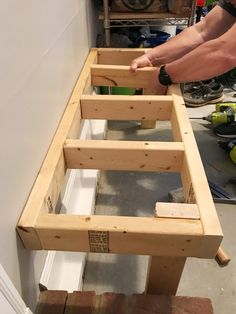 a man is working on some wooden furniture