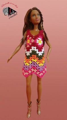 the doll is wearing a dress made out of crochet