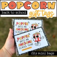 two popcorn bags with the words popcorn back to school written on them in black and white