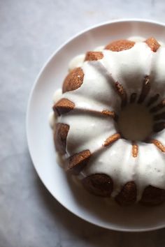 a bundt cake with icing on a white plate