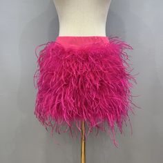 Gorgeous hand made ostrich feather mini skirt. Please refer to the waist and hip measurements in the size chart when ordering. Skirt is made to order in Italy, therefore please allow 4-5 days for production and 5-7 days for shipping. Feather Trim Mini Skirt For Party, Summer Night Out Skirt With Feather Trim, Summer Feather Trim Skirt For Night Out, Summer Party Skirt With Feather Trim, Feather Trim Skirt For Summer Party, Pink Mini Skirt For Costume Party, Feathered Mini Skirt For Summer, Spring Fitted Feather Skirt, Spring Mini Skirt With Feathers