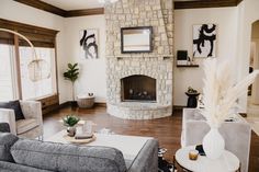 a living room filled with furniture and a fire place in the middle of a room