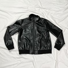 2000s black leather bomber jacket. Made in Italy. In good condition. Note: I try to match colors as much as possible to pictures but there is a possibility it won't be an exact match. Unless the color is completely incorrect I am unable to offer refunds for this reason. Size: medium Brand is A Collezioni Measurements (taken on garment laid flat): Armpit to armpit: 22.5" Waist: 44" Shoulder to shoulder: 18" Armpit to hem: 16.5" Length (top of neck to bottom hem): 29" Fabric: not labeled, feels like real leather Solid Leather Biker Jacket For Streetwear, Solid Leather Jacket With Zipper For Streetwear, Black Winter Varsity Jacket With Zipper Closure, Black Varsity Jacket With Zipper For Winter, Black Varsity Jacket With Zipper Closure For Winter, Fitted Black Leather Varsity Jacket, Match Colors, Y2k Black, Real Leather