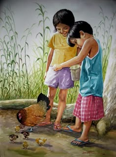 two children feeding chickens in the grass