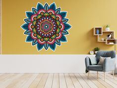 a living room with a chair and a wall decorated with an intricate flower design on the wall