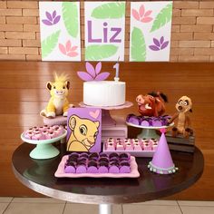 a table topped with lots of cakes and cupcakes