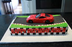 a birthday cake with a red sports car on it