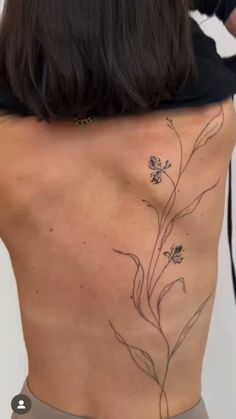 the back of a woman's body with flowers on it